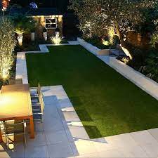 New turf and landscaped backyard at night